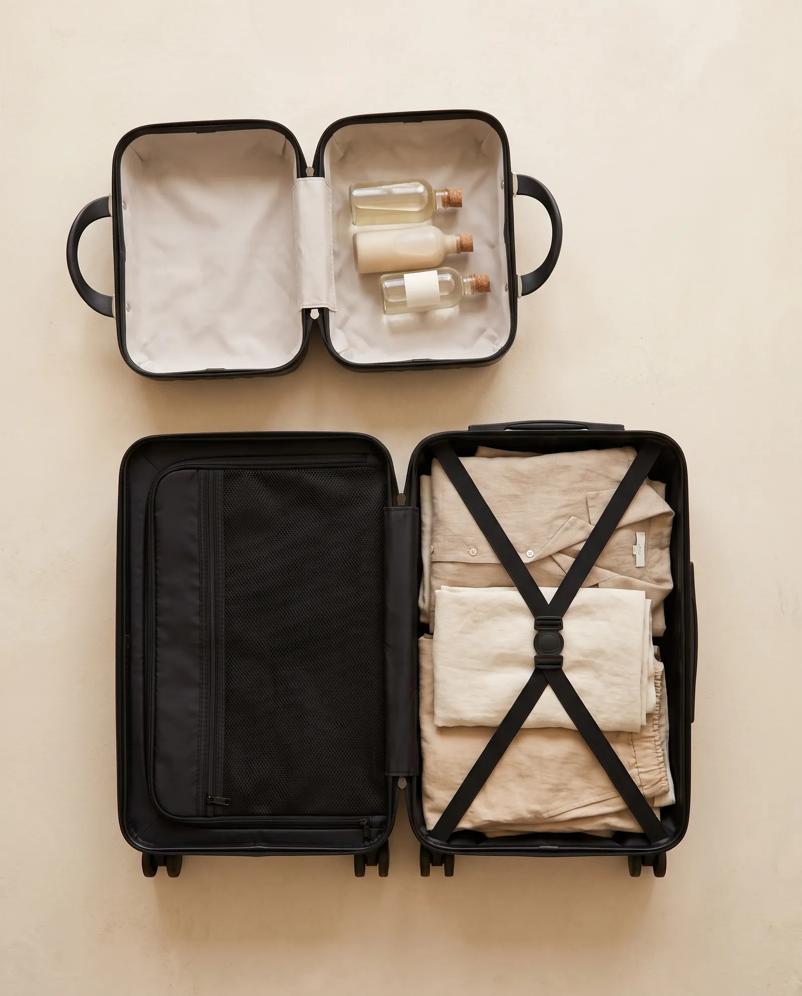 Packed carry-on and open vanity case, top view